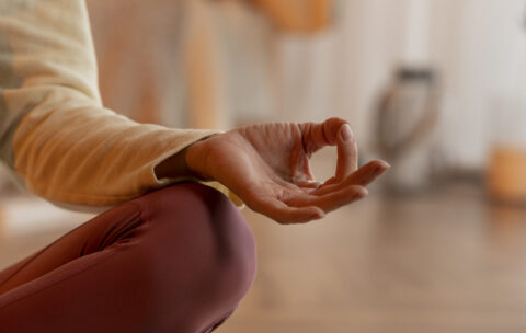 front-view-woman-meditating-mat